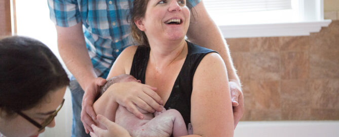 mother birthing baby at Bellingham birth Center