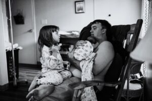 daughter meeting newborn at birth center